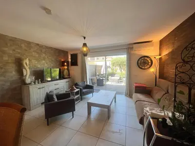 a living room with a couch and a table at FIORINO in Sainte-Lucie de Porto-Vecchio