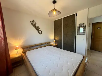 a bedroom with a large bed in a room at FIORINO in Sainte-Lucie de Porto-Vecchio