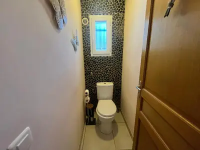 a small bathroom with a toilet and a window at FIORINO in Sainte-Lucie de Porto-Vecchio