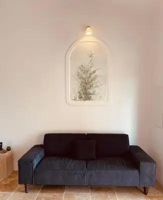 a black couch in a room with a picture on the wall at Domaine Pietra di Sole in Porto-Vecchio