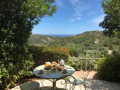 a table with food on it with a view of a mountain at Domaine Pietra di Sole in Porto-Vecchio