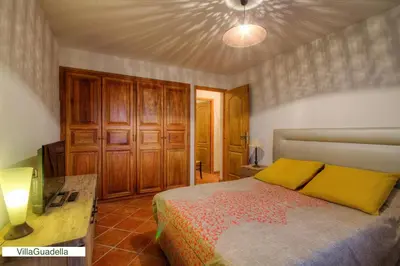 a bedroom with a bed and a table in it at Résidence Casa Di Roc in Urtaca