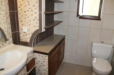 a bathroom with a sink and a toilet at Domaine Le Clos des Oliviers in Sorbo-Ocagnano