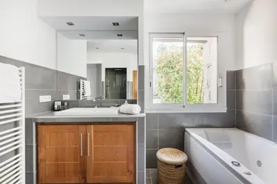 a bathroom with a tub and a sink and a mirror at la villa piana Ardiadoro in Bocca del Oro