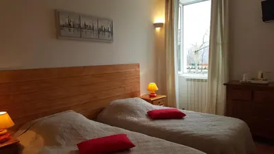 a bedroom with two beds with red pillows on them at U San Larenzu in Aullène