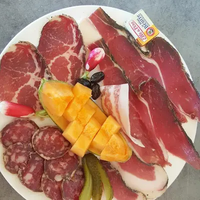 a plate of different types of meats and vegetables at U San Larenzu in Aullène