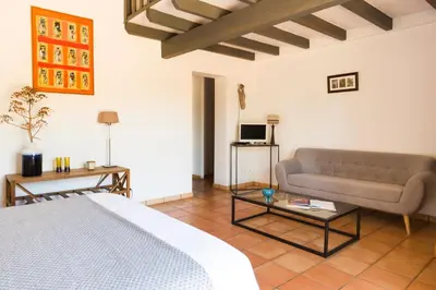 a living room with a bed and a couch at Le Ruone in Calcatoggio