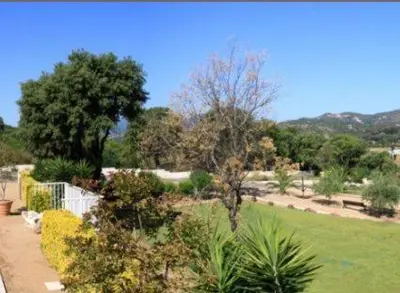 a garden with trees and plants in a park at Résidence Dicieppo in Ajaccio