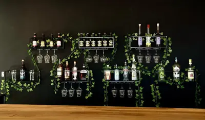 a wall with several bottles of alcohol on it at Residence Canella in Sari Solenzara