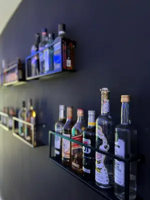 a shelf with several bottles of beer on it at Residence Canella in Sari Solenzara