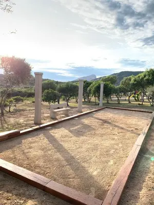 a bench in a park with trees in the background at Résidence & SPA Marina d'Arone in Piana