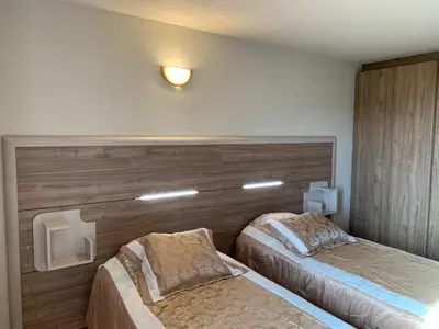 a hotel room with two beds in a room at Résidence & SPA Marina d'Arone in Piana