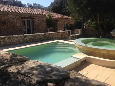 a large pool of water in front of a house at Villa Lavezzi avec piscine in Bonifacio
