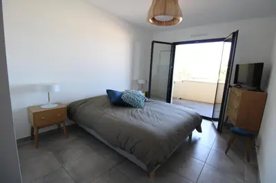 a bedroom with a bed and a tv and a table at Domaine du Frasso in Grosseto-Prugna