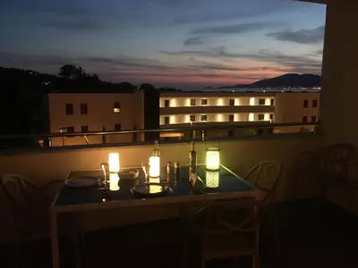 a table on a balcony with lights on it at Domaine du Frasso in Grosseto-Prugna