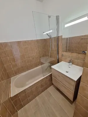 a bathroom with a sink and a bath tub and a mirror at Le Parc Impérial in Ajaccio