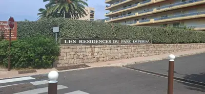 a stone wall with a sign that reads lessresorians do park imperialism at Le Parc Impérial in Ajaccio