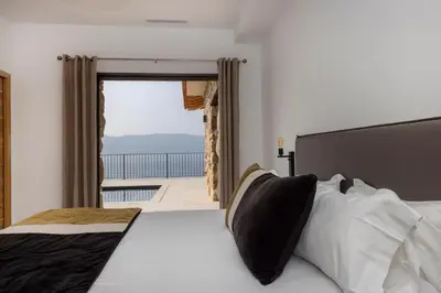 a bedroom with a bed and a view of the ocean at Résidence La Plage in Propriano