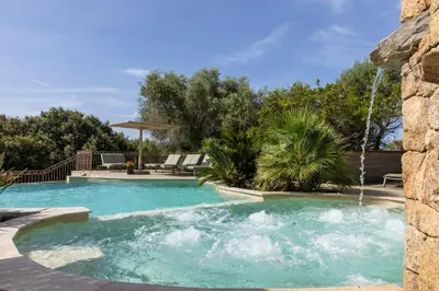 a swimming pool with a water fountain at Résidence La Plage in Propriano