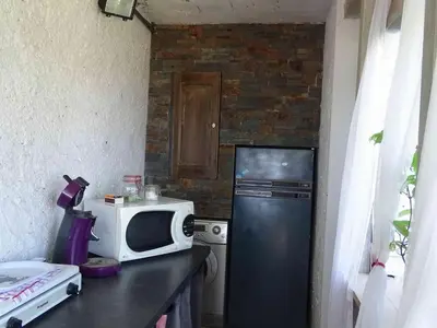 a kitchen with a black refrigerator and a microwave at CASA PENTONE in Cervione