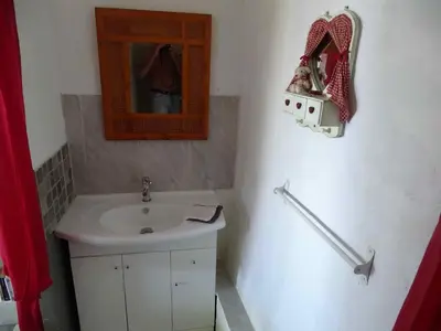 a bathroom with a sink and a mirror at CASA PENTONE in Cervione