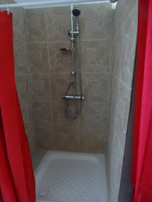 a shower with a red shower curtain and a tub at CASA PENTONE in Cervione