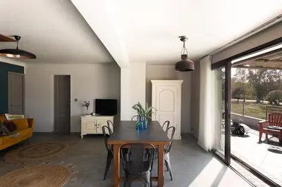 a living room with a table and a couch at Résidence I Levri in Porto-Vecchio