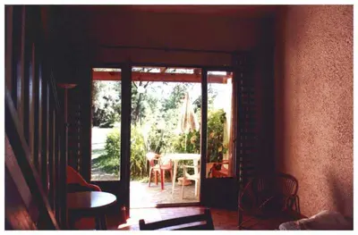 an open door to a patio with a table and chairs at Domaine de l'Avidanella in Santa-Lucia-di-Moriani