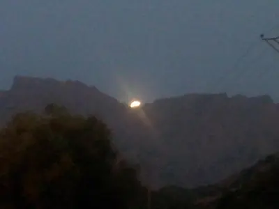 a light on top of a mountain at night at Au pont de Tuarelli, Ludique, Galeria, Corse in Manso