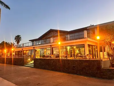 a building with tables and chairs in front of it at Hotel & Restaurant San Pellegrino in Folelli