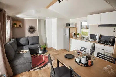 a living room and kitchen with a couch and a table at Residence Marea Resort in Santa-Lucia-di-Moriani