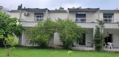 a white house with trees in front of it at Résidence Valledoro in Valle-di-Campoloro