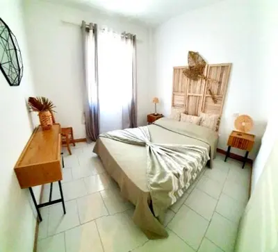 a bedroom with a bed and a desk and a window at Résidence Valledoro in Valle-di-Campoloro