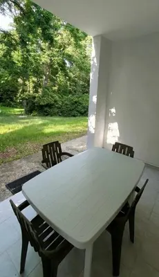 a white table and chairs in a room with a window at Résidence Valledoro in Valle-di-Campoloro