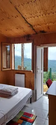 a bedroom with a bed and a door with windows at DISCRET, APAISANT, CALME entre MER et MONTAGNE, THERMALISME in Isolaccio-di-Fiumorbo