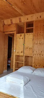 a wooden room with a bed in a room with wooden walls at DISCRET, APAISANT, CALME entre MER et MONTAGNE, THERMALISME in Isolaccio-di-Fiumorbo