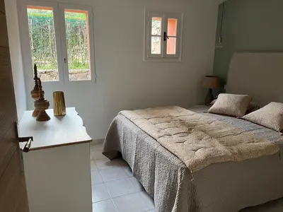a bedroom with a bed and a window at Maison Le Citronnier avec piscine - Domaine E Case Di Cuttoli in Cuttoli-Corticchiato
