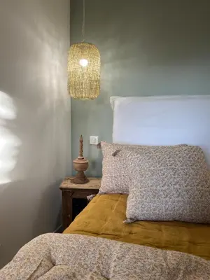a bedroom with a bed and a pendant light at Maison Le Citronnier avec piscine - Domaine E Case Di Cuttoli in Cuttoli-Corticchiato