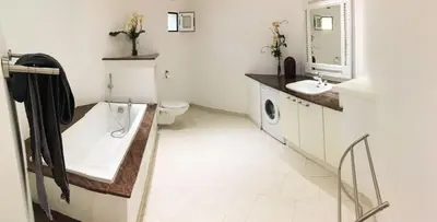 a bathroom with a tub and a sink and a toilet at Maison L'Oranger avec piscine - Domaine E Case di Cuttoli in Cuttoli-Corticchiato