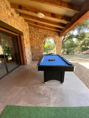 a pool table sitting inside of a building at Maison L'Oranger avec piscine - Domaine E Case di Cuttoli in Cuttoli-Corticchiato