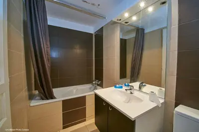 a bathroom with a sink and a bath tub at Maison L'Olivier avec piscine in Cuttoli-Corticchiato