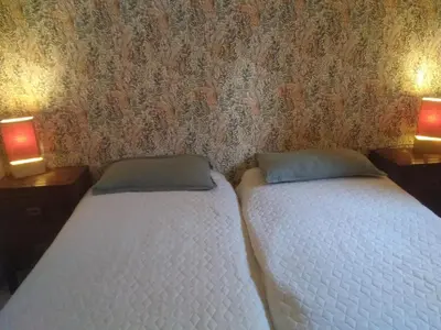 two twin beds in a bedroom with two lamps at Maison L'Olivier avec piscine in Cuttoli-Corticchiato