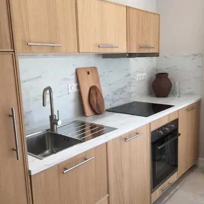 a kitchen with a sink and a stove top oven at L'Aiglon in Serriera