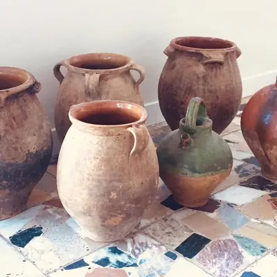 a group of clay vases sitting on a table at L'Aiglon in Serriera