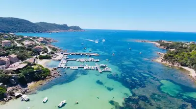an aerial view of a beach with boats in the water at Hôtel du Golfe in Sartène