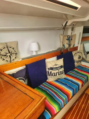 a bed on a boat with colorful blankets and pillows at seuls à bord dans le golfe hebergement atypique in Porto-Vecchio