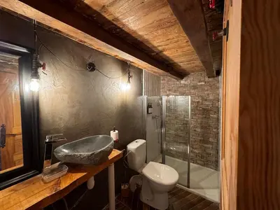 a bathroom with a sink and a toilet and a shower at Location atypique village olmeto in Olmeto