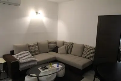 a living room with a couch and a table at Appartement Sampiero in Corte