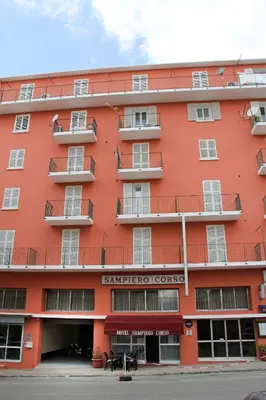 a red building with the word embassy court on it at Appartement Sampiero in Corte