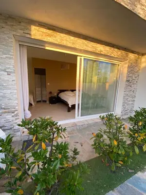 a sliding glass door to a bedroom with a bed at Vizzavona Piscine in Ajaccio